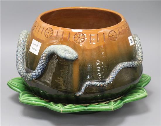 A C.H. Brannam Barum ware brown and green glazed bowl, the body encircled by a snake, together with a green glazed dish (2)